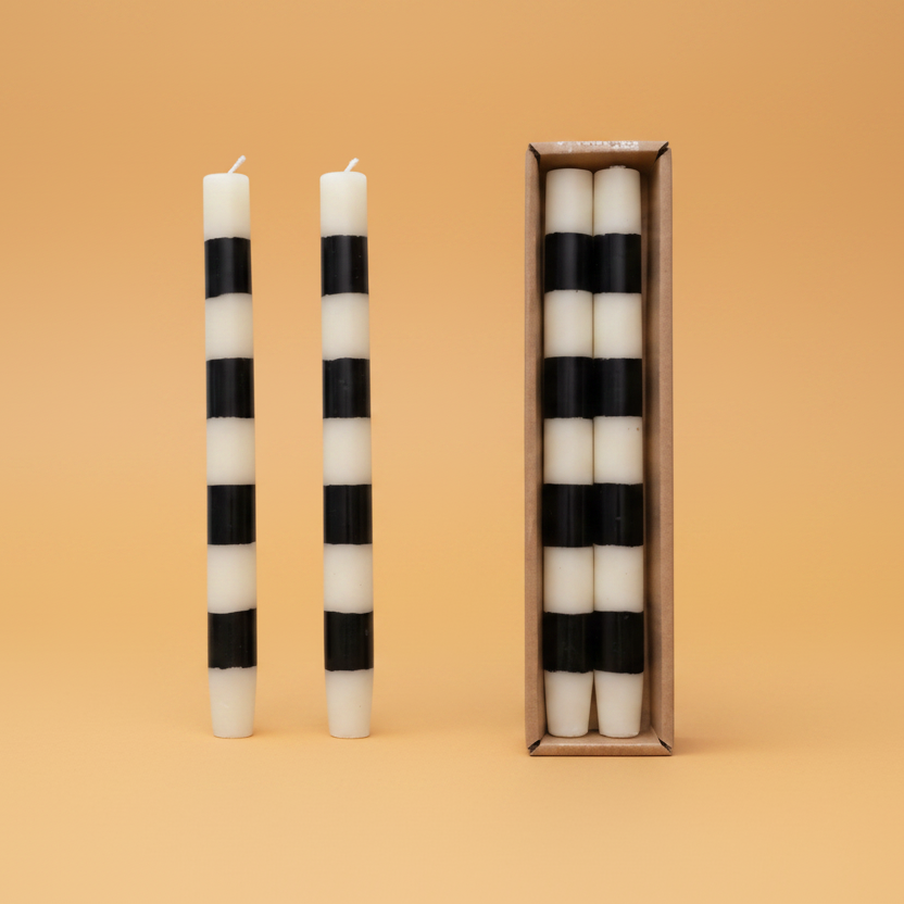 Set the mood with our Unscented Taper Candles featuring playful stripes. Includes a set of two candles in a convenient box. No need for overpowering scents, just enjoy the warm, flickering light. Perfect for any occasion, without taking itself too seriously. Black & White Stripes