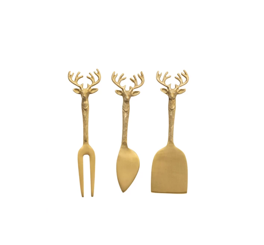 This set of 3 brass cheese knives features reindeer handles that add a festive charm to the tableware. The knives have different shapes and functions. They are ideal for slicing, spreading, or serving cheeses, from soft to hard varieties. The knives come in a printed drawstring bag, which makes them easy to store and gift. The knives are made of brass metal, which is durable, shiny, and easy to clean. 