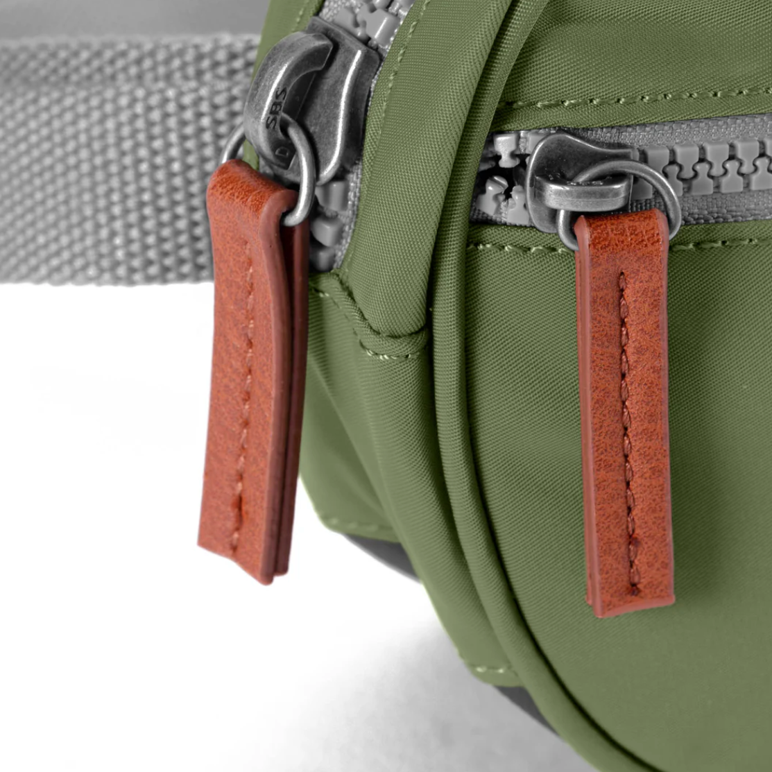 With a front zip pocket, a secret pocket inside, and plenty of space for your keys, sunglasses, and mobile phone this little hip bag is going to change your life in a big way! With an adjustable waist strap and sturdy zips, this little treasure is made with weather-resistant, recycled nylon material.