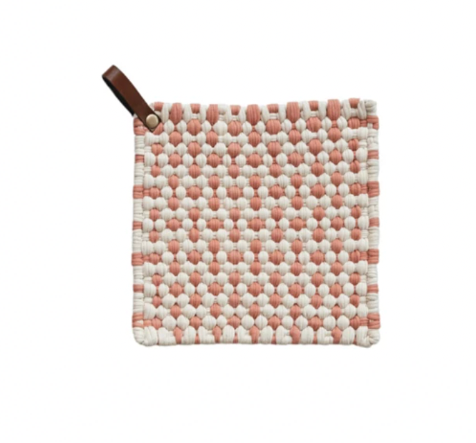This pink and white square cotton crocheted pot holder with a leather loop is a cozy and rustic addition to the home or office kitchen. It features a square shape and a cotton crocheted design providing protection from hot pots and pans. The holder's leather loop allows easy storage and access.