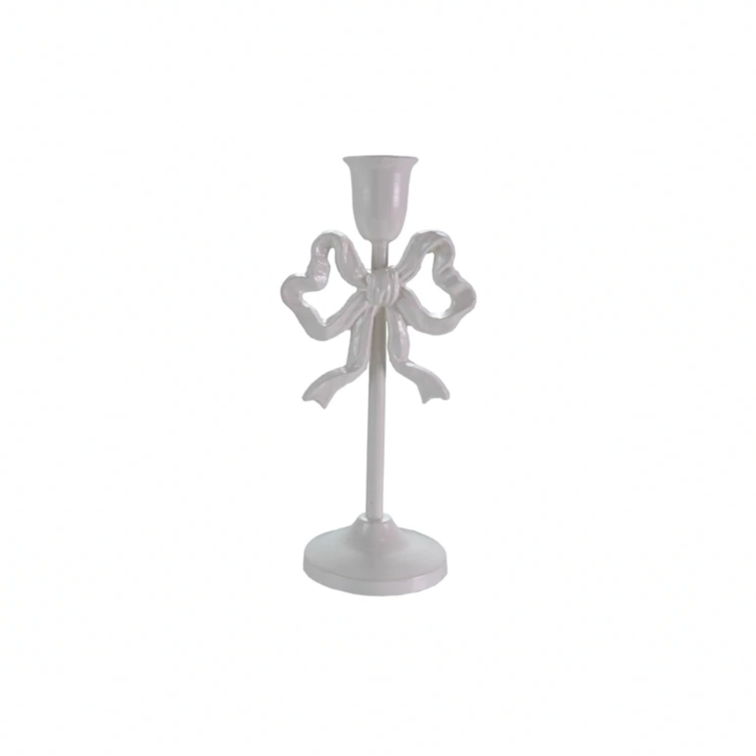 White candle holder with a decorative bow on a white background