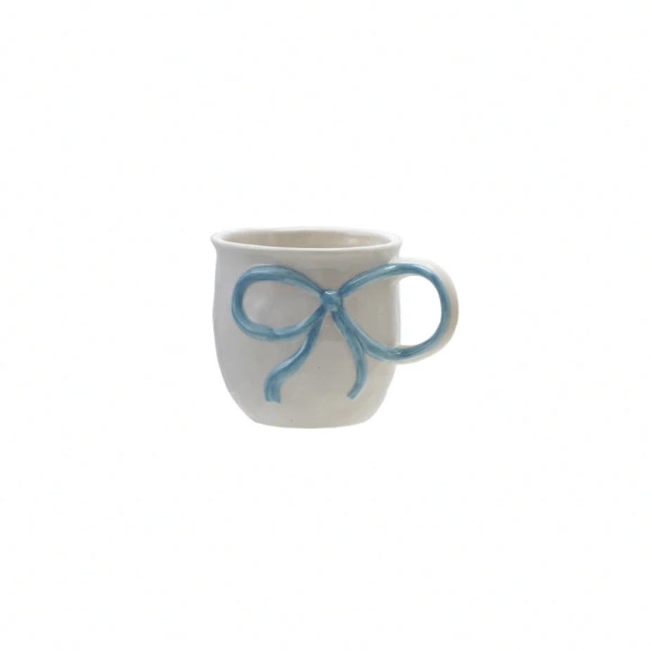 White mug with a blue bow handle on a white background