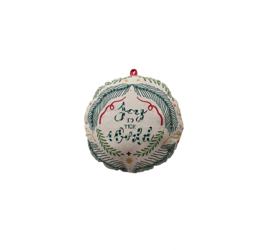 Decorative Christmas ornament with text and greenery on a white background