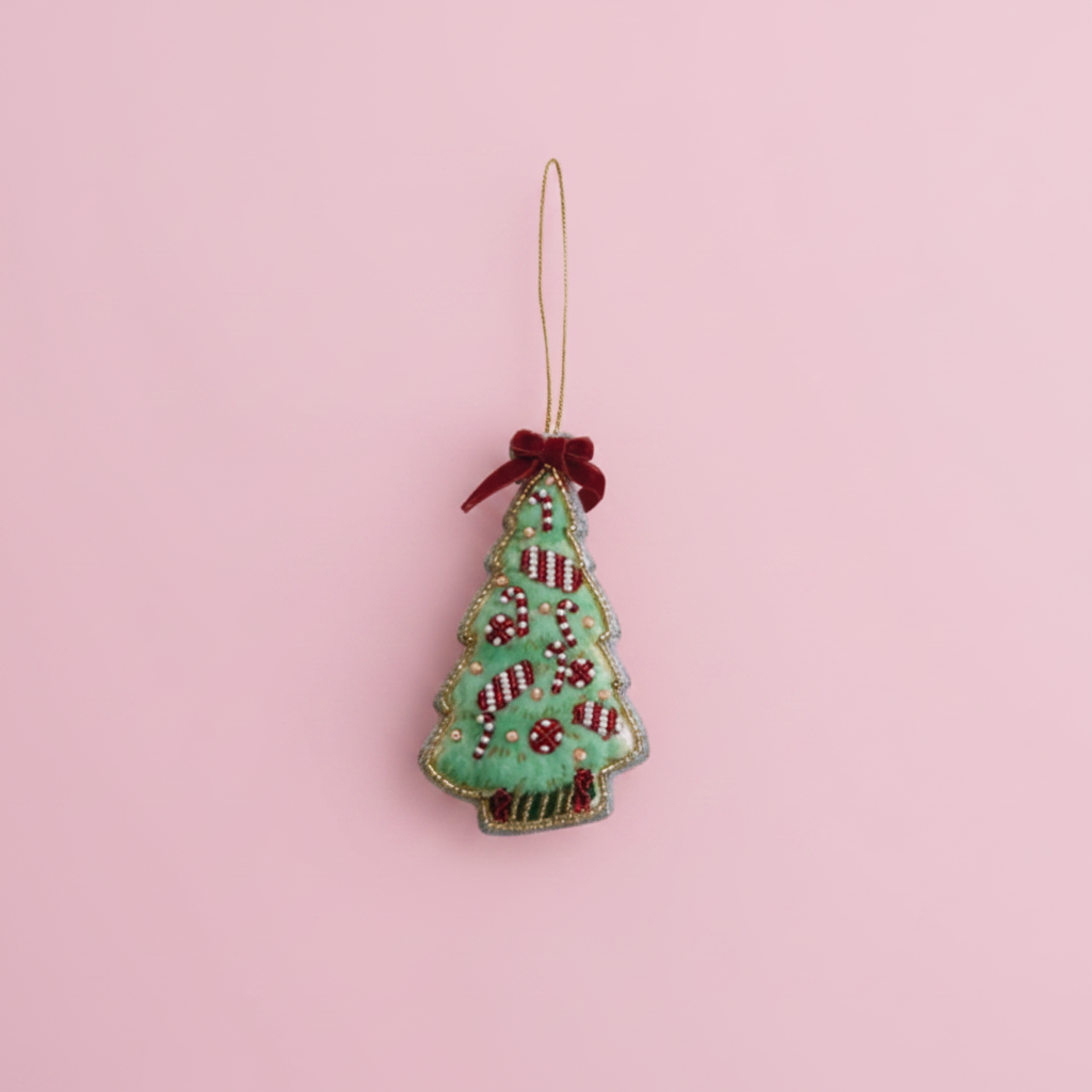 Decorative Christmas tree ornament with red berries on a white background
