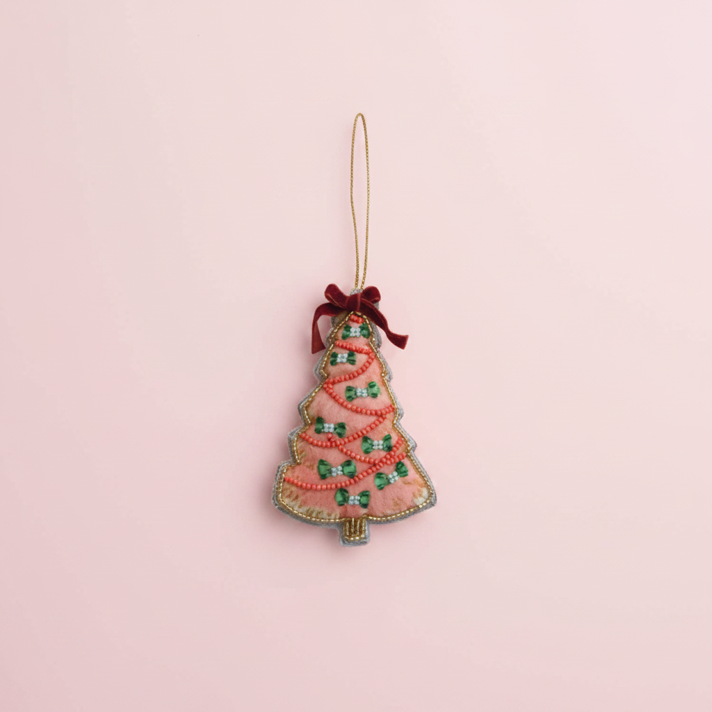 Decorative Christmas tree ornament with a pink base and green decorations on a white background