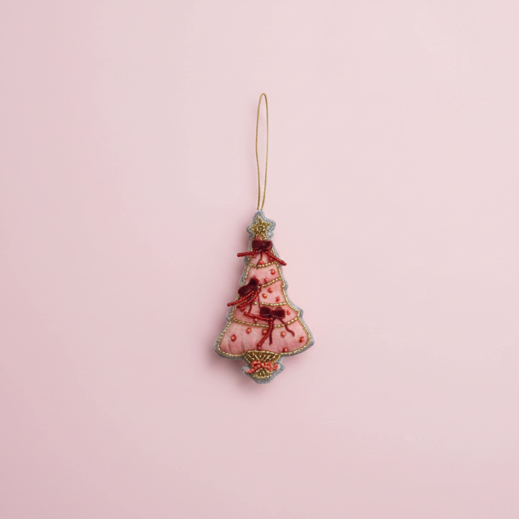 Decorative Christmas tree ornament with pink and gold details on a white background