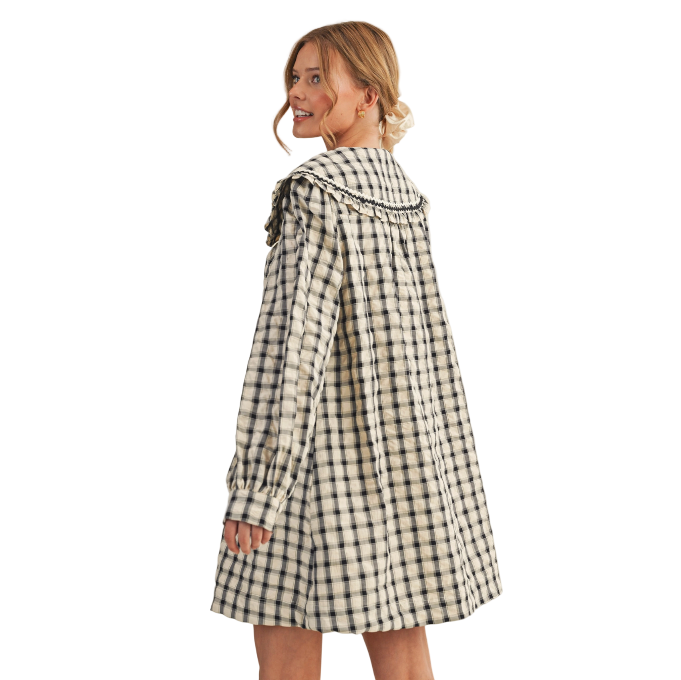Woman wearing a black and white checkered dress on a white background