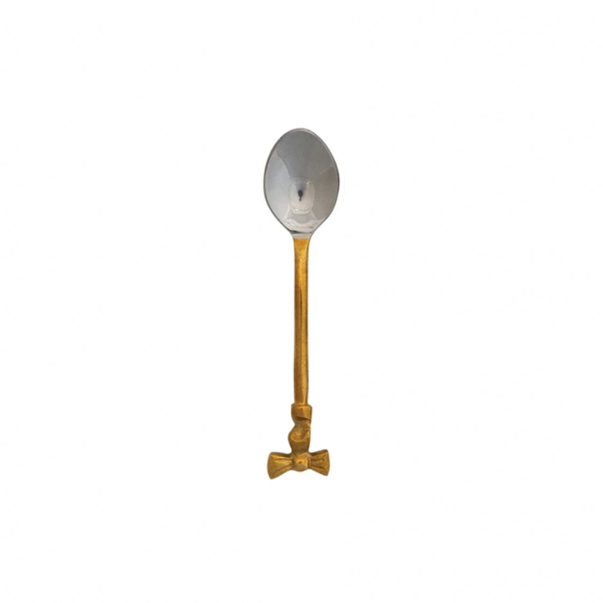 Spoon with gold handle & bow on top of handle on a white background