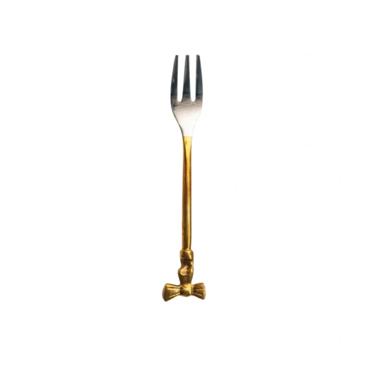 Gold fork with a bow design on HANDLE ON a white background