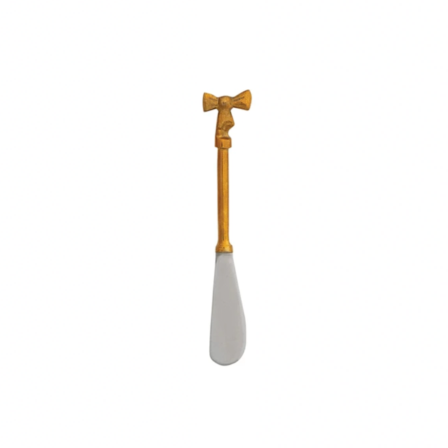 Gold-handled white knife with bow handle on a white background