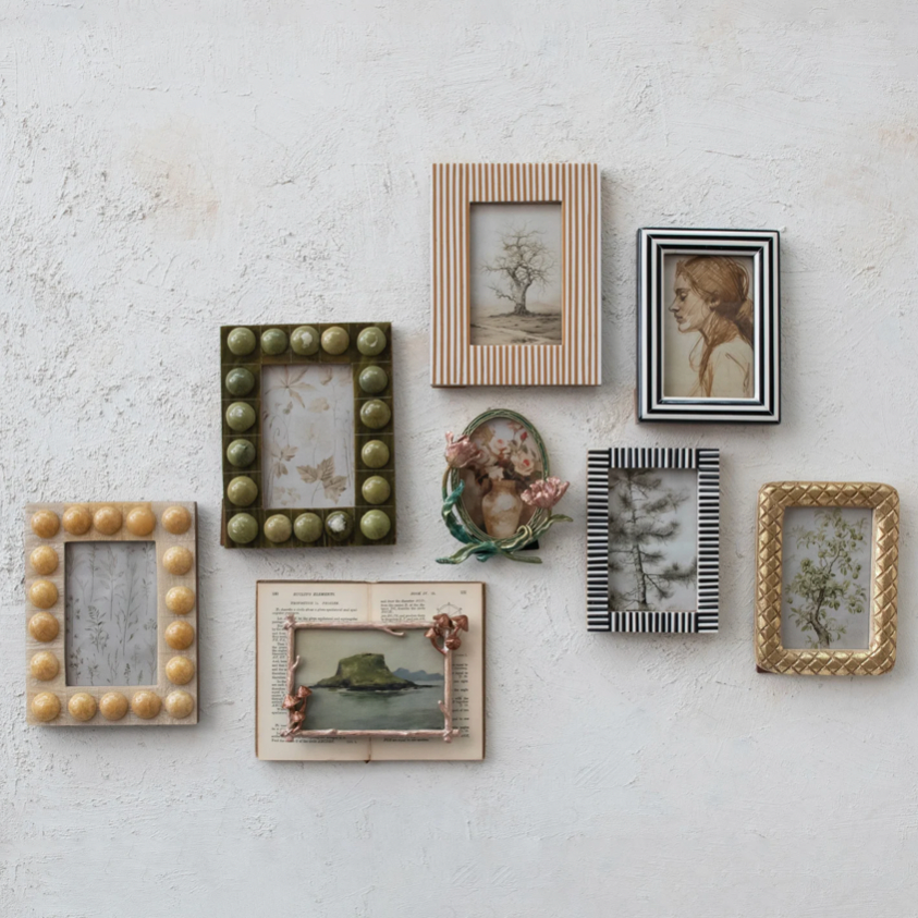 Collection of decorative picture frames on a textured wall