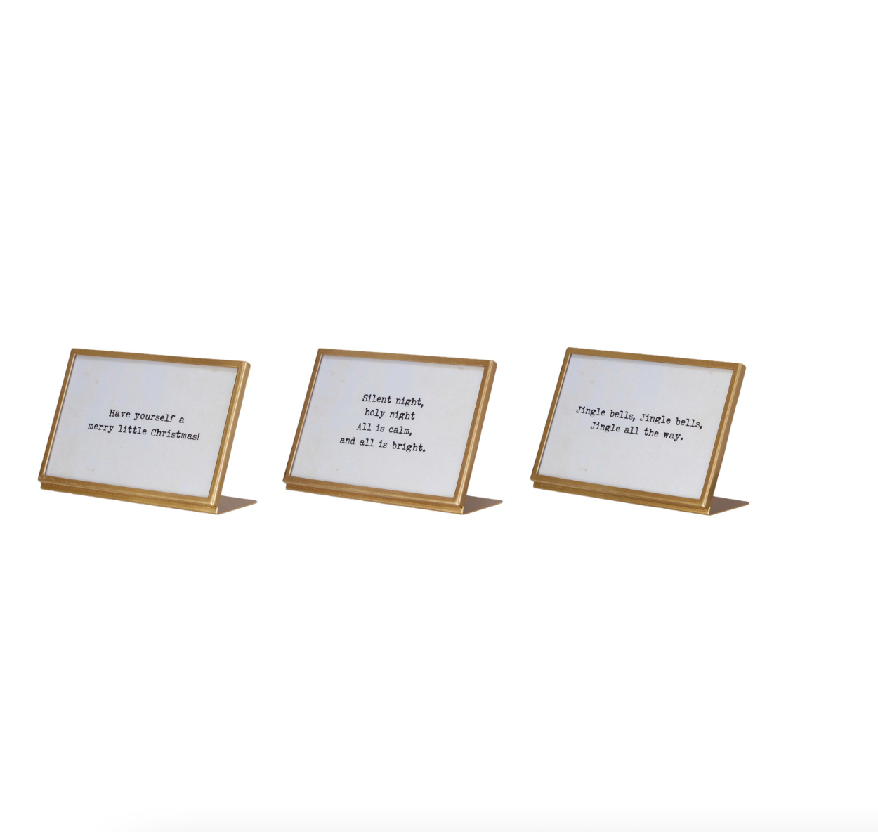 Three gold-framed signs with white backgrounds on a white background