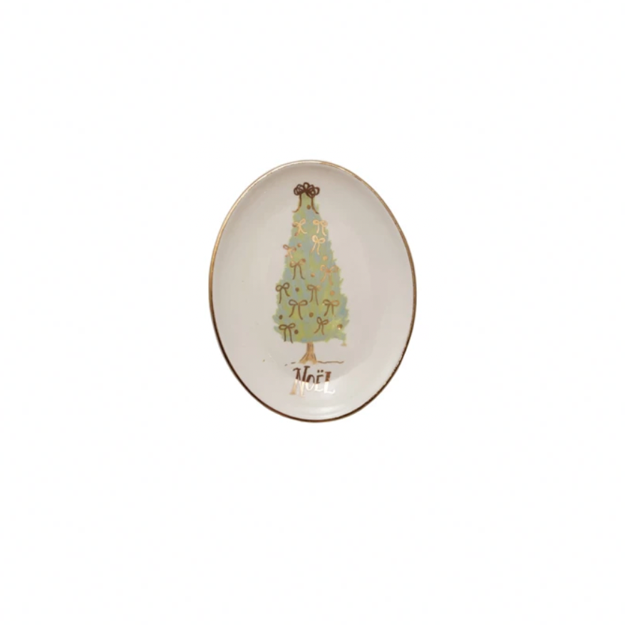 Decorative oval plate with a Christmas tree design & the words Noel on it. on a white background