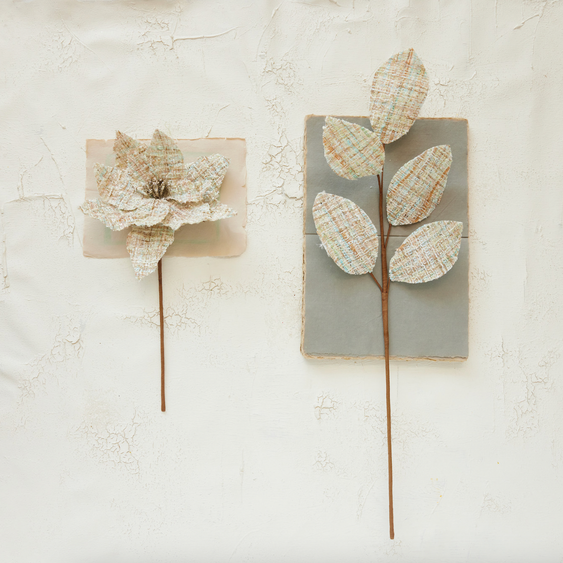 Decorative wall art with floral designs on wooden panels against a light background