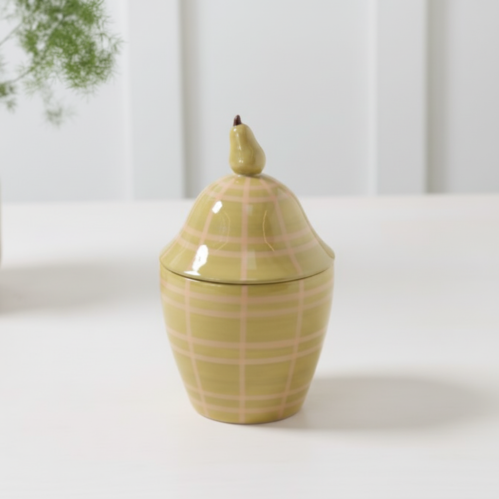 Beautiful olive green tapered jar with a lid. The lid has a dainty pair on the top. Soft pink plaid design.
