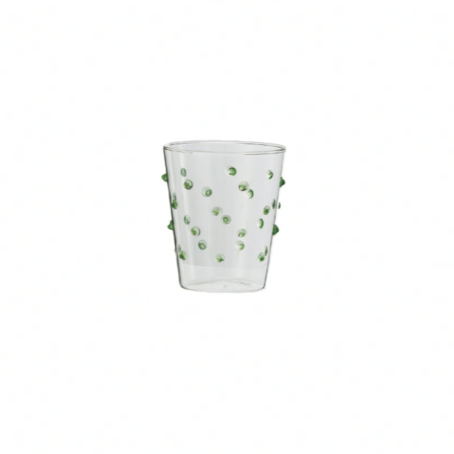 Clear glass with green decorative elements on a white background