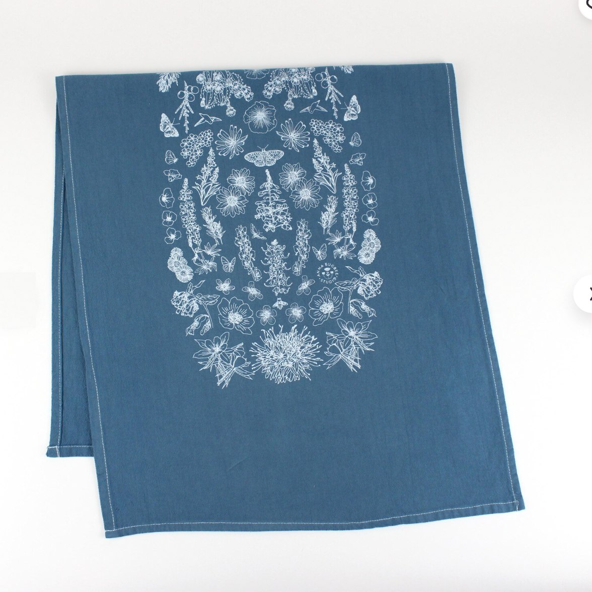 Blue towel with white floral pattern on a white background