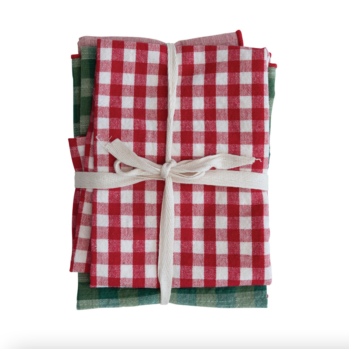 A stack of folded checkered kitchen towels or napkins tied with a cream ribbon, featuring a red and white gingham pattern on top with green and white plaid layers underneath, set against a plain white background.