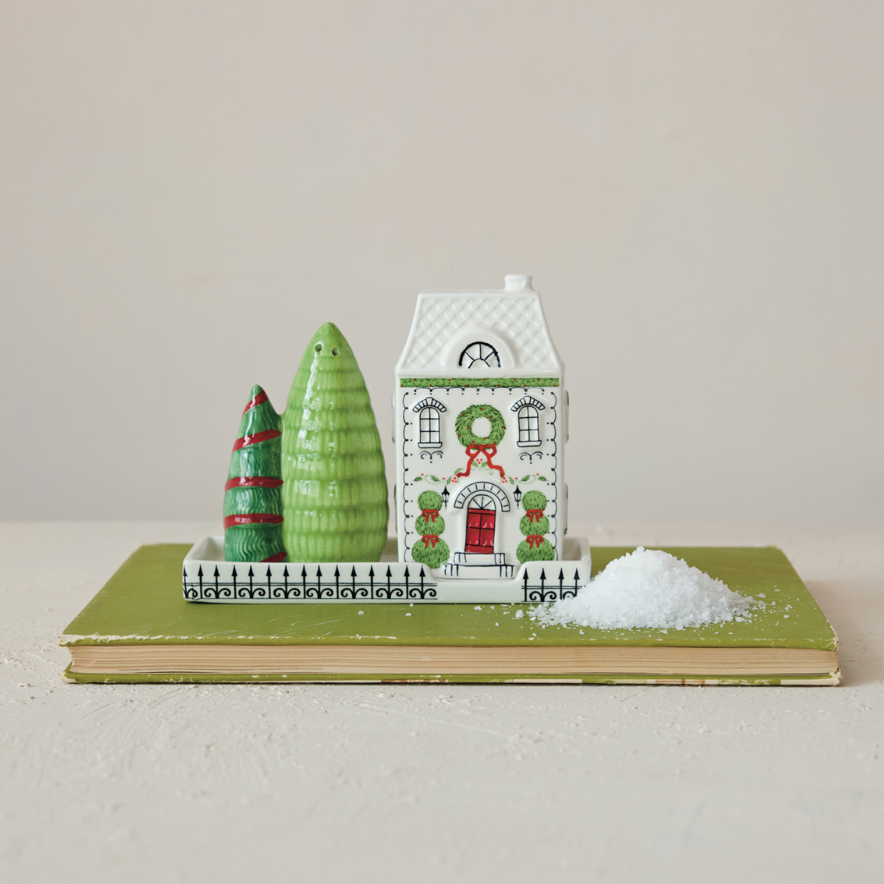 Ceramic Holiday Street Salt & Pepper Shaker Set. Bring festive warmth and cozy charm to your dining table with this Ceramic Holiday Street Salt & Pepper Shaker Set. Complete with cute house and tree shakers on their own matching tray, it adds a delightful seasonal touch to every shared meal.