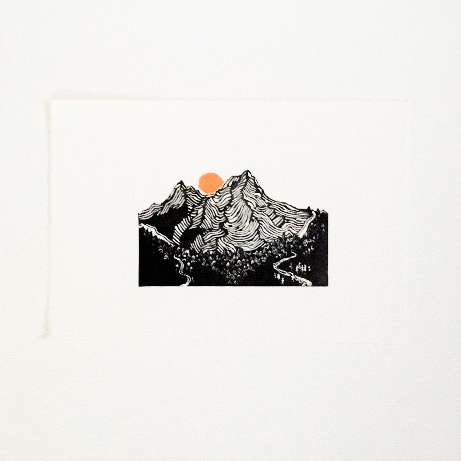 hand carved and pressed black and white 11x14 print of 2 of the 3 sisters mountain range with an orange sun
