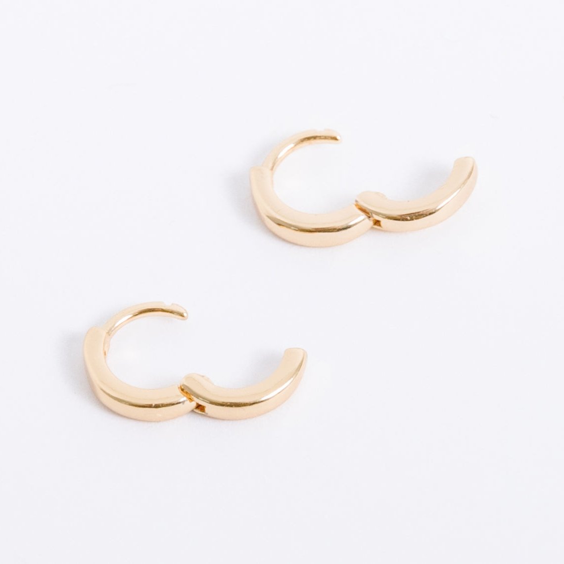 14k gold filled. Safe for sensitive skin. Unique clasp has no post when earrings are closed, allowing for comfortable wear and sleep without having to remove earrings. Available in 9 mm and 16 mm, Hypoallergenic, While gold filled is a strong, sturdy metal for maximum lifespan we don't recommend subjecting the earrings to lots of chemicals, waters, perfumes, etc.