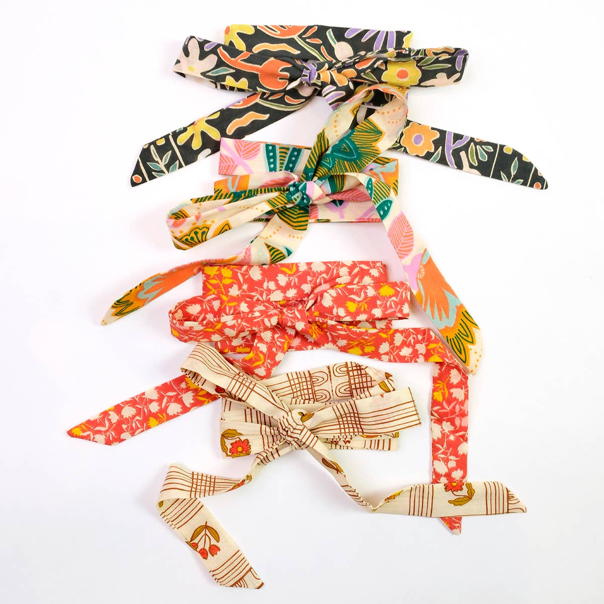 Collection of colorful hair ties with various patterns on a white background