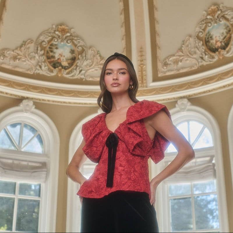 The Maryn Jacquard Luci Babydoll Top combines comfort and style with its soft jacquard fabric and flattering babydoll fit. Its ruffled short sleeves and delicate black velvet tie create a gentle, feminine look that feels as good as it looks. Designed to support your confidence, this blouse is a versatile addition that works effortlessly for any occasion.