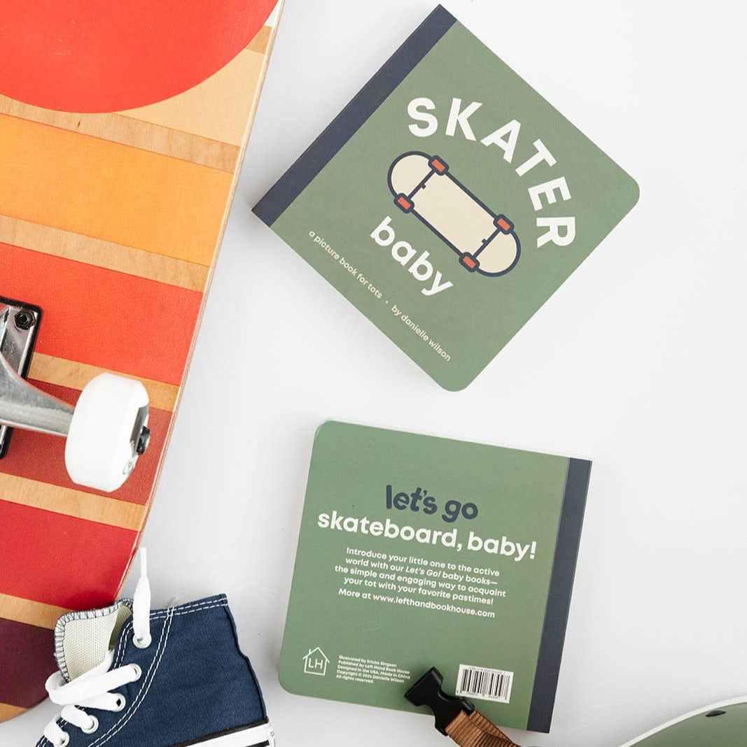 Two green books titled 'Skater baby' and 'let's go skateboard, baby!' on a white surface with a colorful skateboard and blue sneakers.