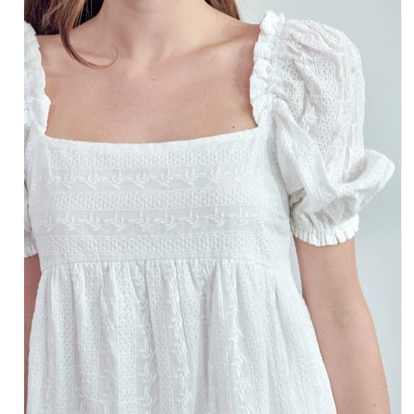 Get ready to turn heads in this quirky and playful Square Neck White Mini Dress! With its unique puff sleeve detail and flattering square neckline, this dress is perfect for any occasion. It's time to add a touch of fun and style to your wardrobe with this must-have piece.