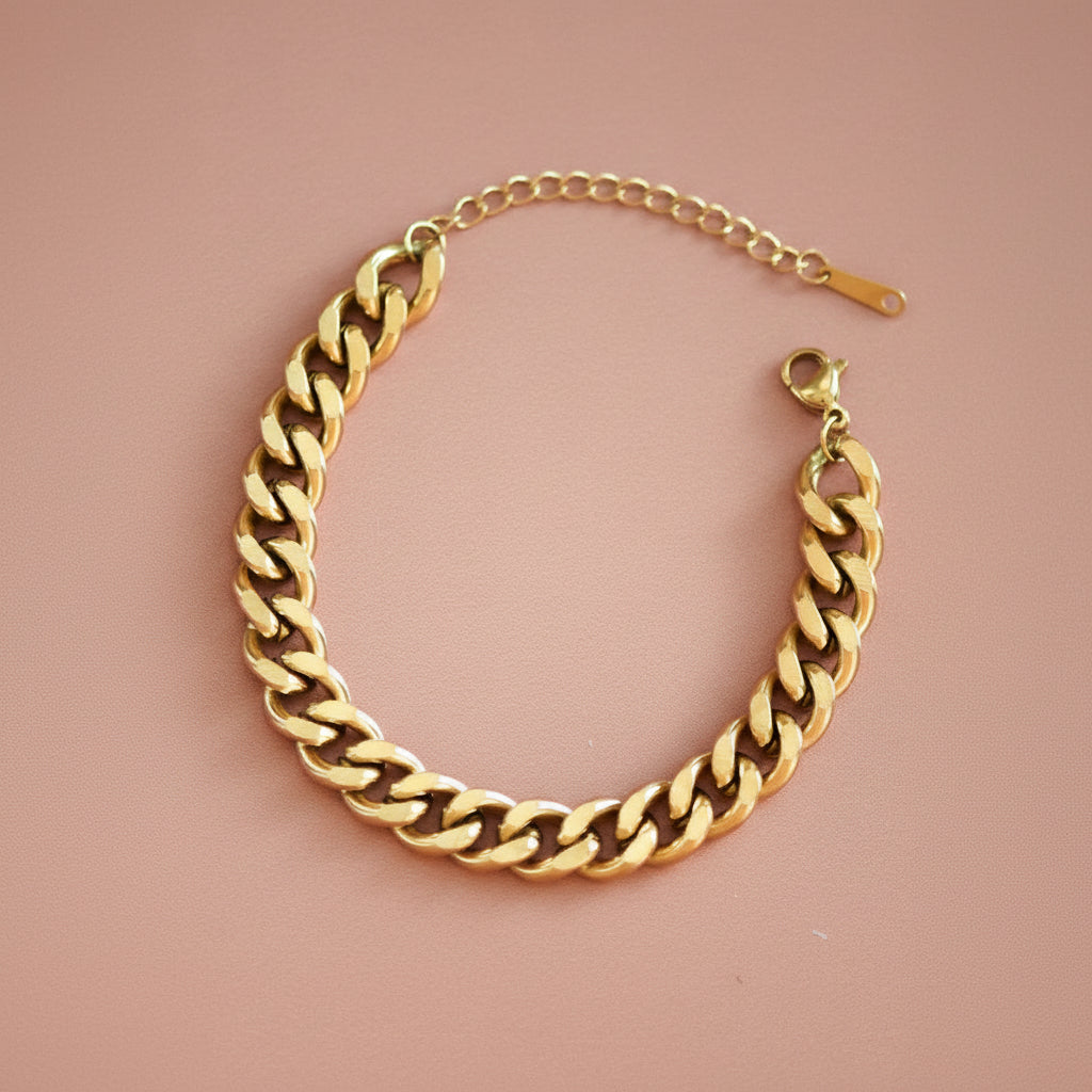 Elevate your wrist with this stunning 18K gold plated chain link bracelet, crafted from hypoallergenic stainless steel. Designed to withstand daily wear, it's waterproof and tarnish-resistant for lasting brilliance. The chunky chain style makes a bold statement while remaining comfortable for all-day wear. To maintain its lustrous finish, avoid prolonged contact with lotions, perfumes, and cleaning products. A versatile piece that transitions seamlessly from casual to elegant occasions.