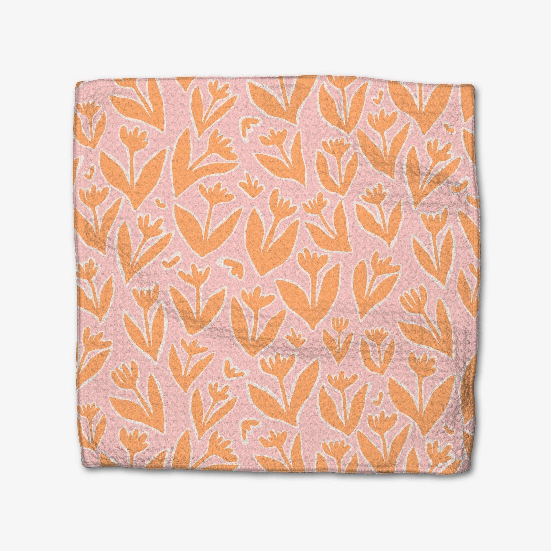 Floral patterned fabric with orange flowers on a pink background