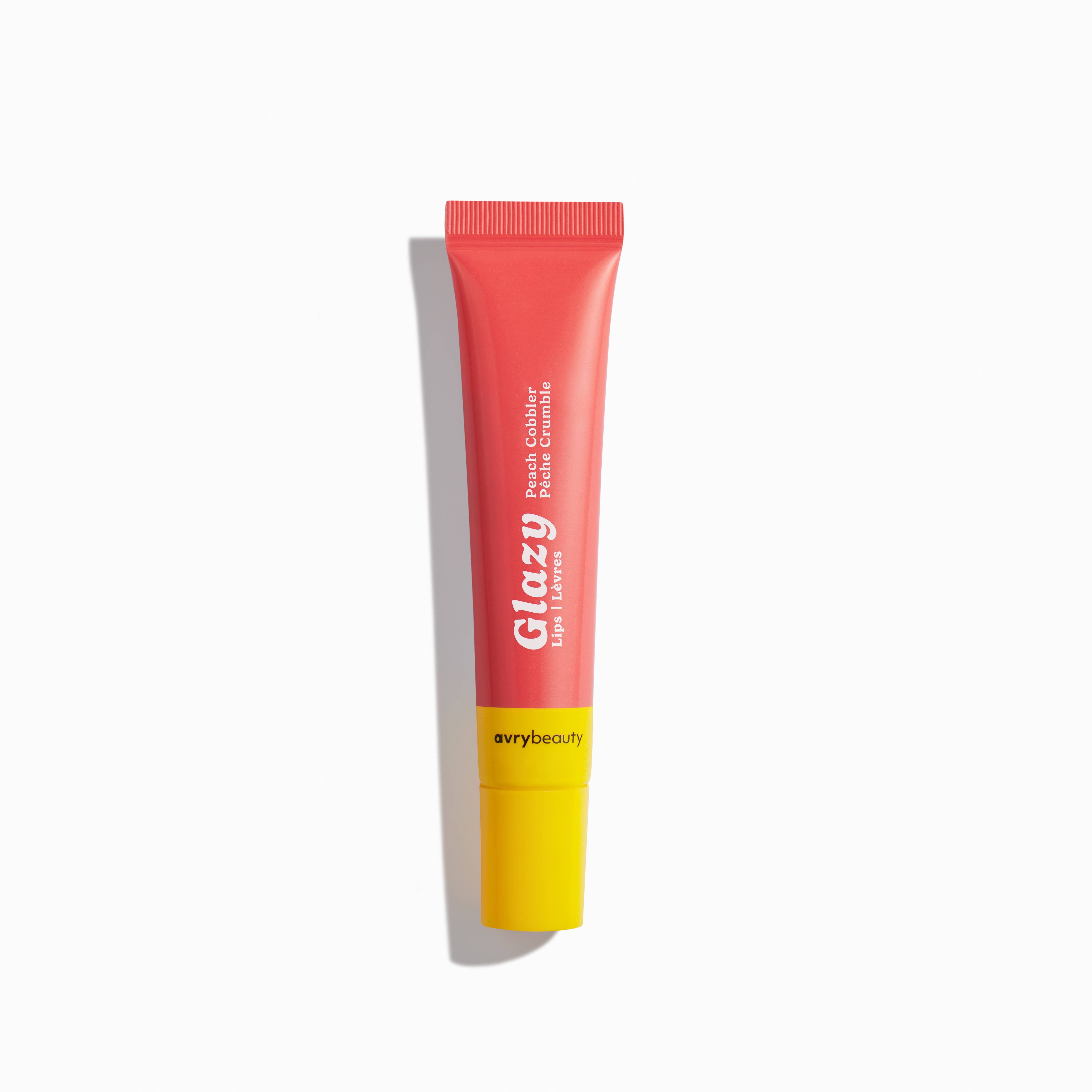 Glazy lip balm tube with pink cap and yellow base on a white background