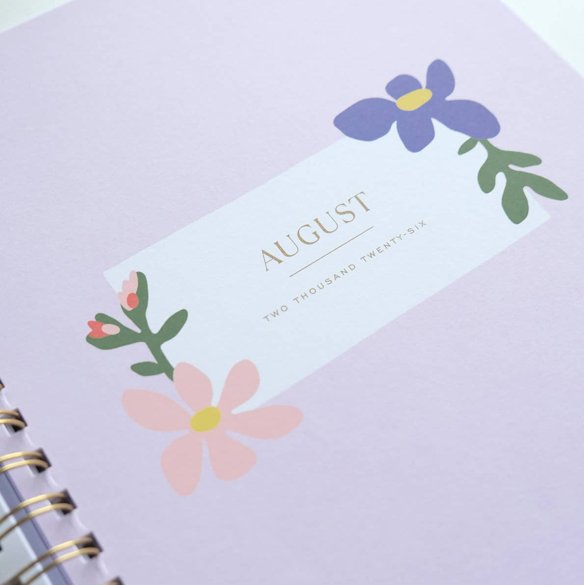 Purple planner with floral design and 'August' text on a white background