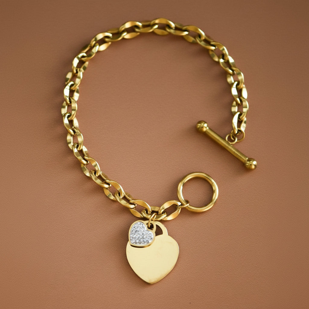 Elevate your everyday style with this stunning 18K gold plated stainless steel chain link bracelet. Crafted from hypoallergenic materials, it's perfect for sensitive skin and designed to withstand daily wear with its waterproof and tarnish-resistant properties. This bracelet features two charming heart accents—one classic gold heart and one sparkly heart charm—adding a touch of elegance and personality to your wrist.