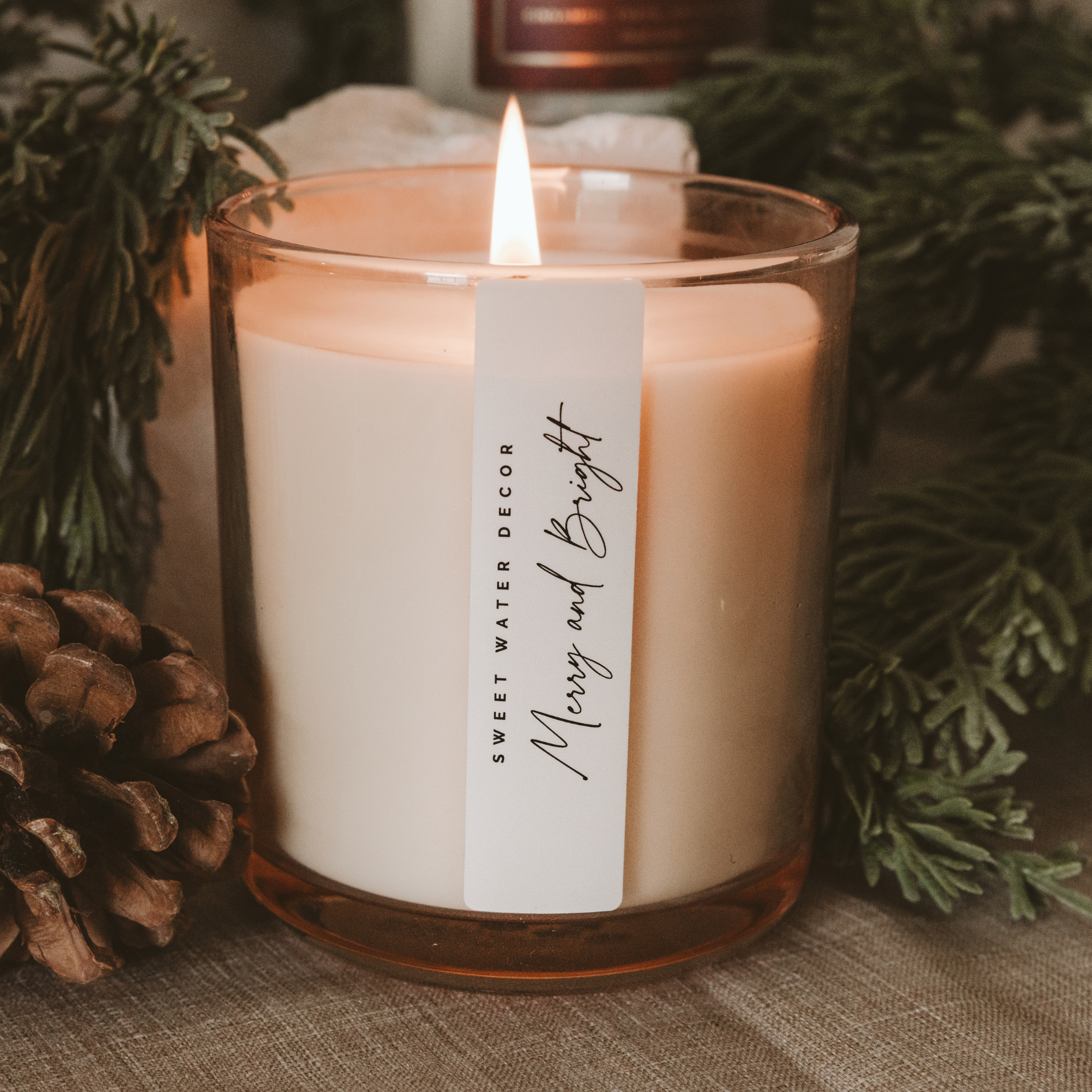 Our Merry and Bright fragrance combines warm bayberry, clove, nutmeg, and cedar to create a cozy, inviting scent that embodies the spirit of Christmas.
Presented in an elegant tinted glass jar, its classic design fits effortlessly into any holiday decor. Perfect for holiday candle collections, seasonal displays, and thoughtful stocking stuffers that bring warmth and cheer to every home.