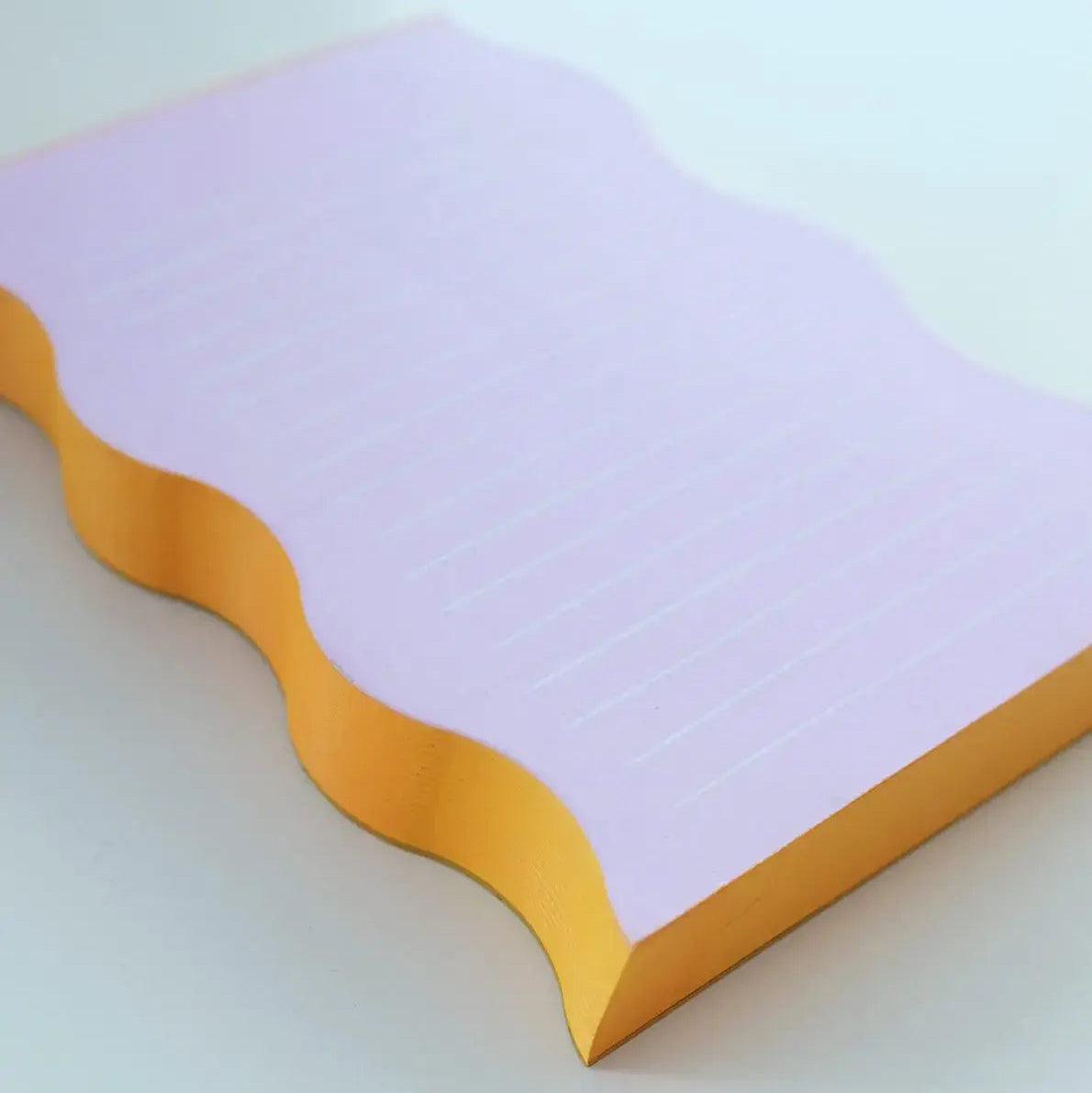 Notebook with purple PAPER and yellow edge on a white background
