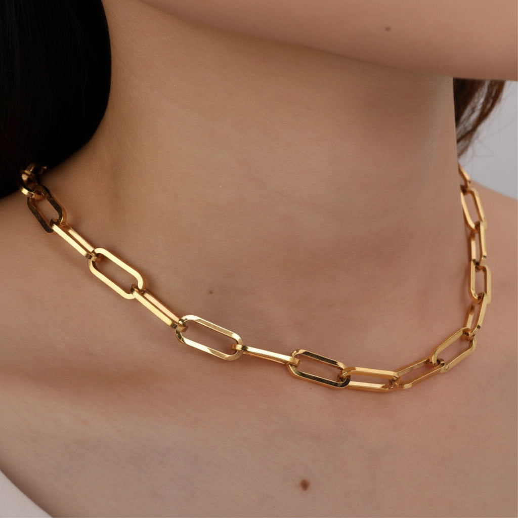 Elevate your everyday style with this striking 18K gold plated stainless steel paperclip chain necklace. Featuring chunky, substantial links that make a bold statement, this 16" necklace includes a 2" extender for customizable length and comfort. Crafted for durability, it's hypoallergenic, waterproof, and tarnish-resistant—perfect for layering or wearing solo. The real gold plating delivers a luxe finish that complements any look, from casual to dressed up.