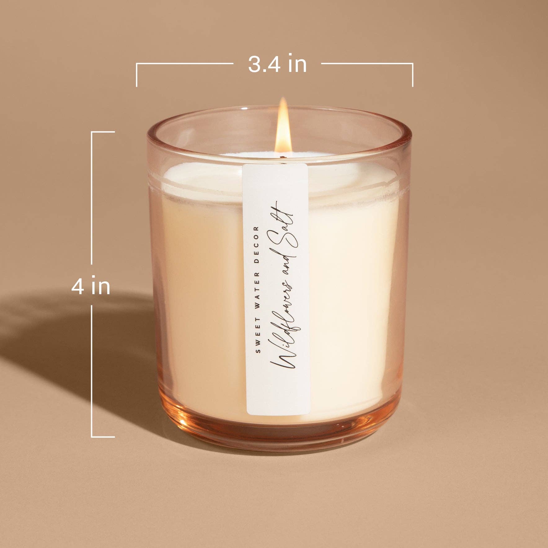 Candle with dimensions labeled on a beige background