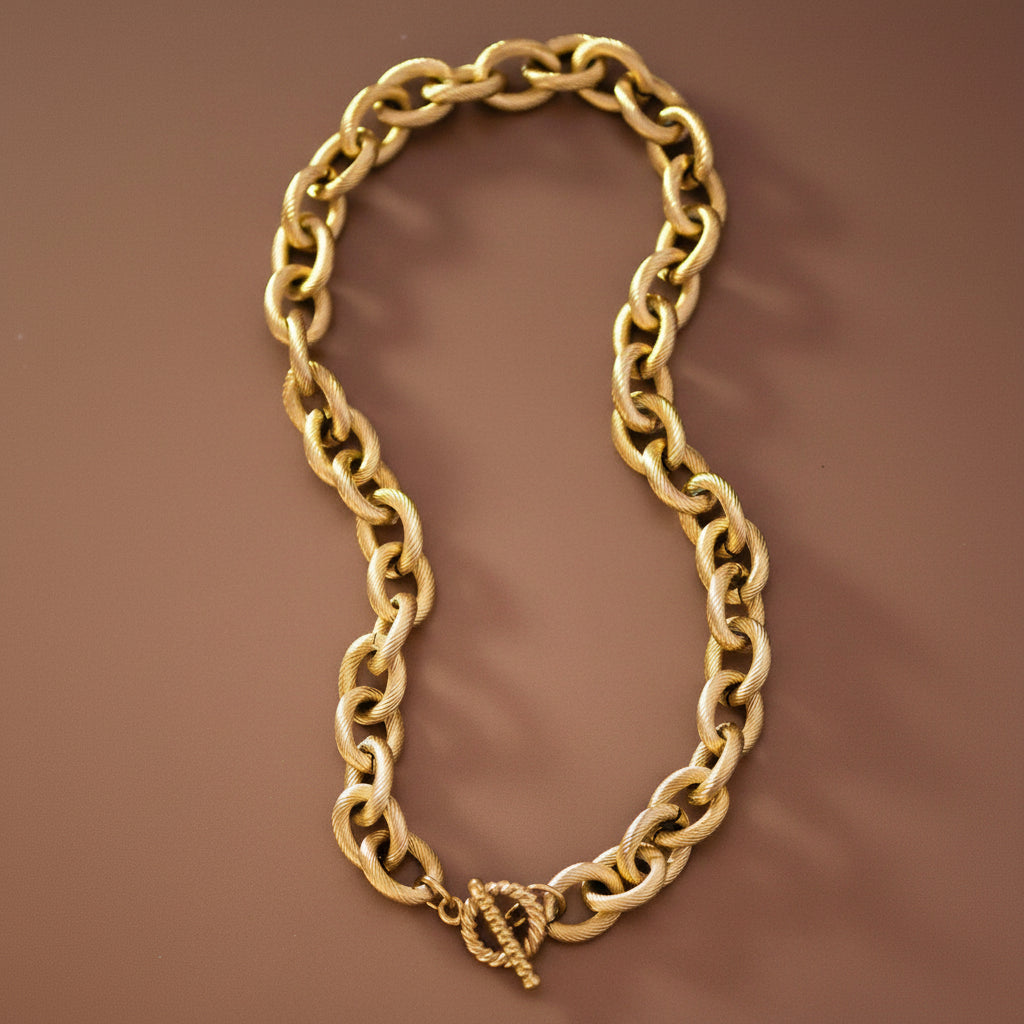 Elevate your everyday style with this chunky chain necklace, a timeless staple that works with any outfit. Crafted from waterproof, hypoallergenic stainless steel with 18K gold plating, this thick link design measures approximately 17" and resists tarnishing. The simple yet bold aesthetic makes it perfect for layering or wearing solo. To maintain its lustrous finish, avoid prolonged contact with lotions, perfumes, and cleaning products. A versatile piece that combines durability with understated elegance.