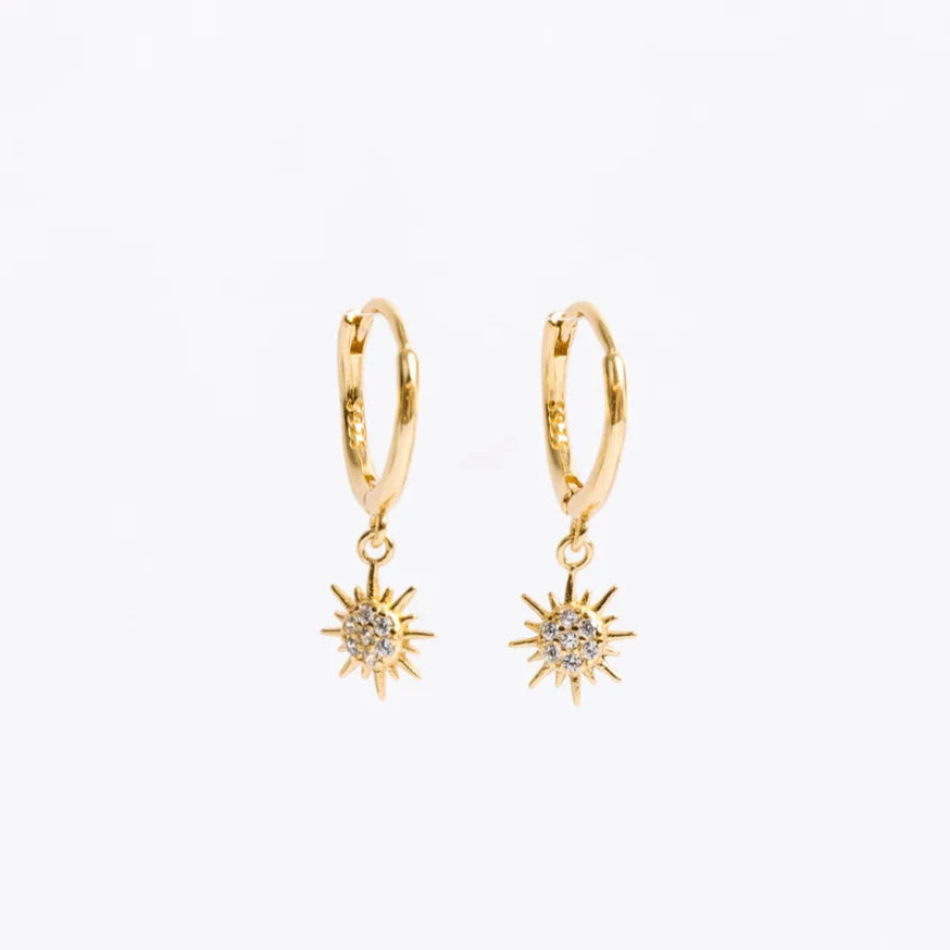 These huggies are FUN. 11 mm hoops with light dangling suns catch the eye while somehow remaining totally chic and totally classic. Same high-quality metal. Same comfortable clasp.