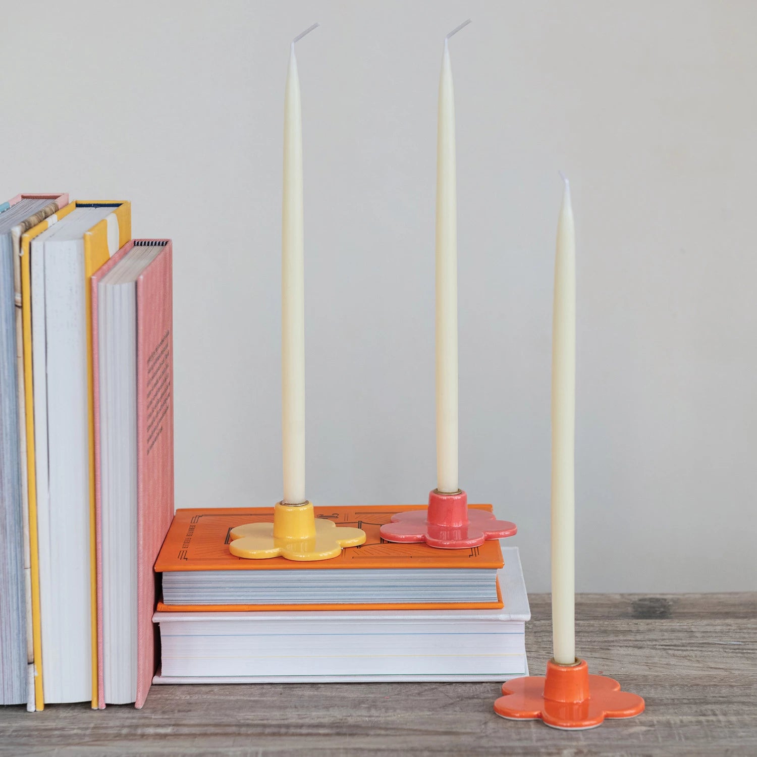 Add a touch of whimsy to your decor with our Stoneware Flower Shaped Taper Holder, available in 3 colors. This holder not only holds your taper candles securely, but also doubles as a charming tabletop accent. Brighten up any room with this playful and unique piece! 3"L x 3"W