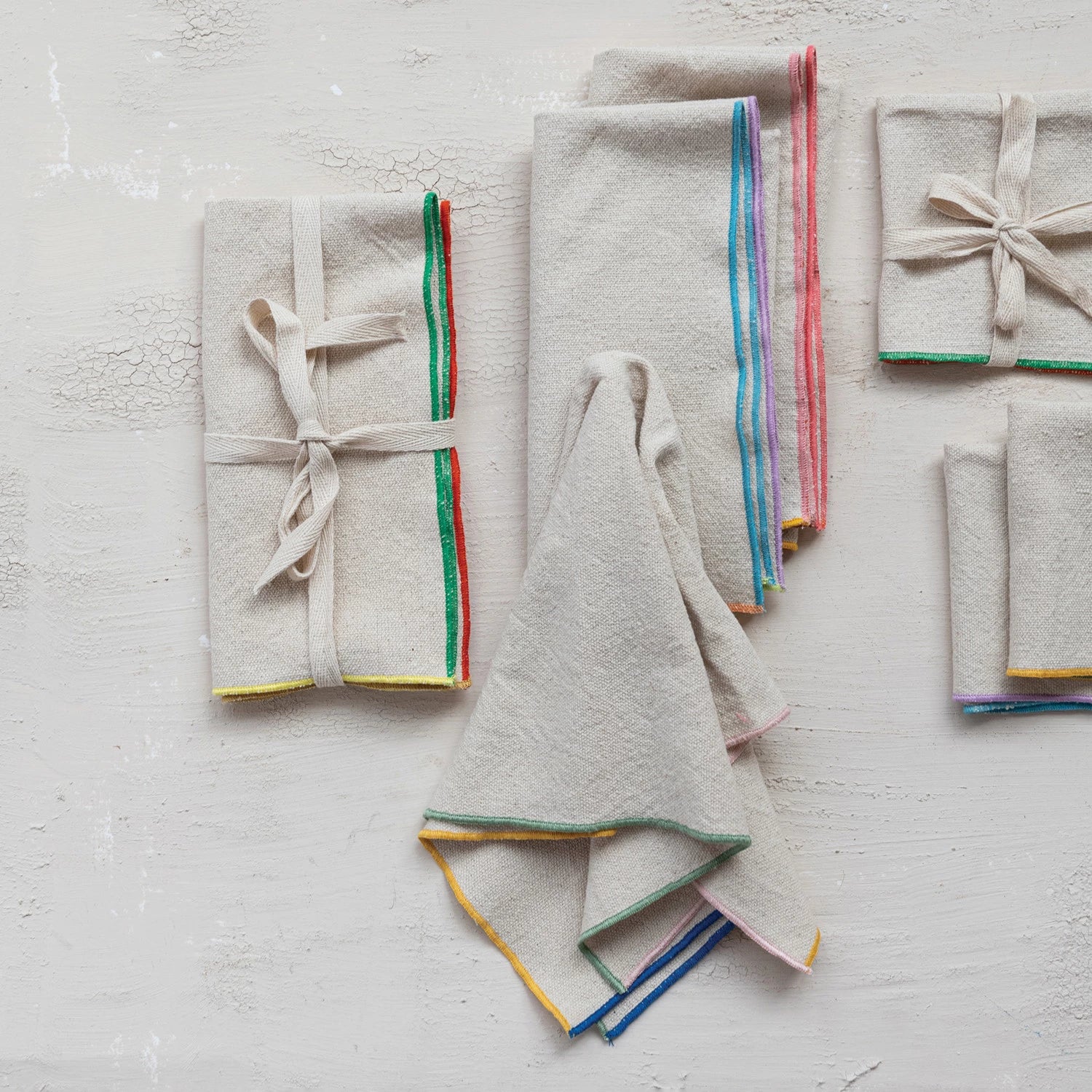 Make your dining experience colorful and charming with our Woven Cotton Napkins! These napkins feature a stitched colored edge, adding a playful touch to any table setting. Made of high-quality cotton, they're durable and easy to clean, making them the perfect addition to your kitchen. Set of 4 included.