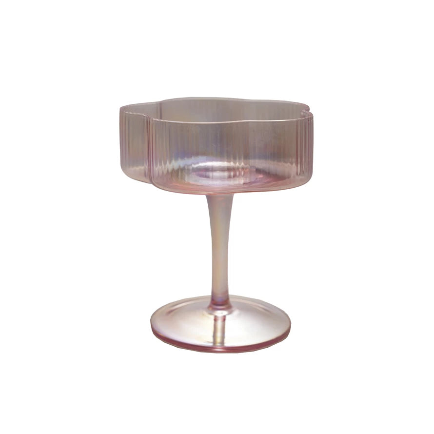 Sip in style with our Hand-Blown Pleated Flower Shaped Stemmed Coupe Glass. Its unique design adds a touch of whimsy to any cocktail, while the hand-blown craftsmanship ensures a high-quality and one-of-a-kind drinking experience. Cheers to sophisticated playfulness! 4" Round x 4-1/2"H. 6 oz.