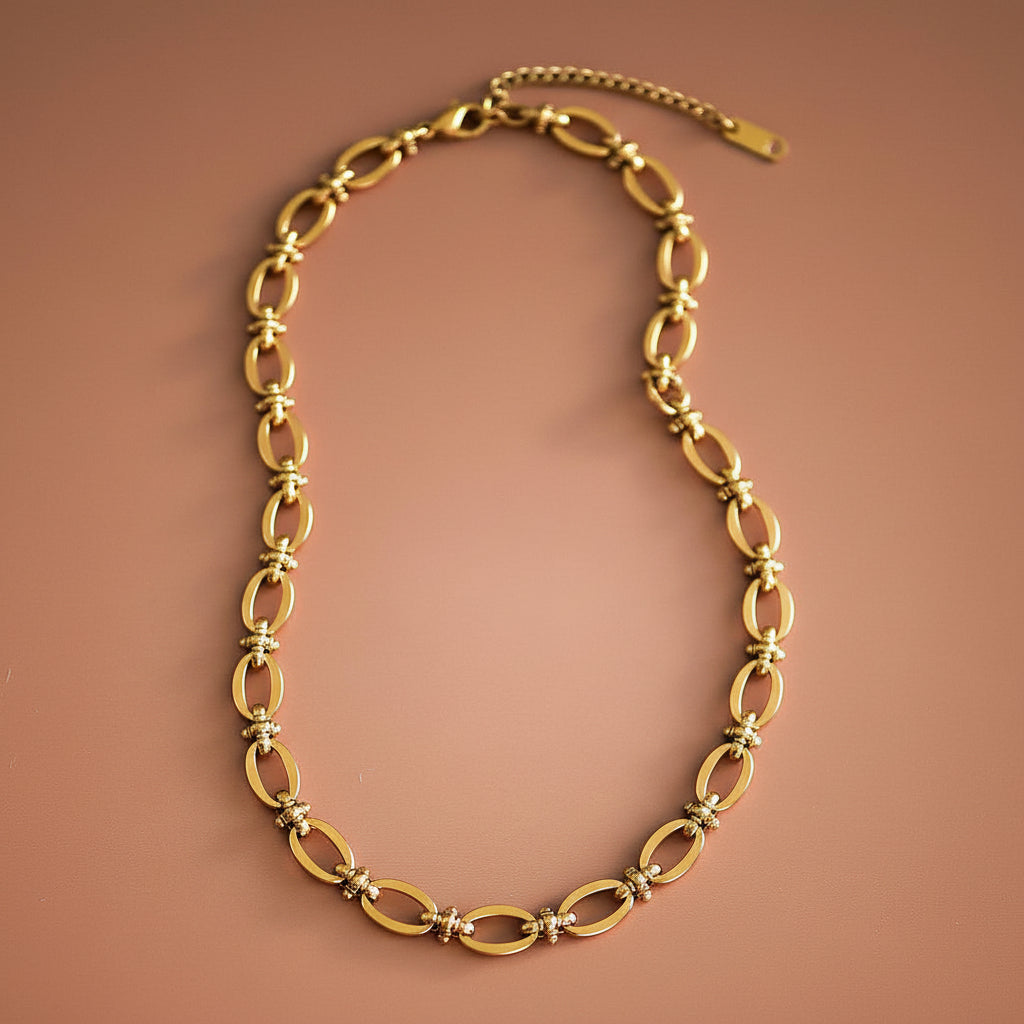 18K Gold Dipped Stainless Steel Oval Chain Necklace Elevate your everyday style with this timeless oval chain necklace, crafted from hypoallergenic stainless steel and finished with 18K gold plating. Measuring approximately 18 inches with an adjustable extender, it offers the perfect fit for any neckline. Designed for durability, this necklace is waterproof and tarnish-resistant, making it ideal for daily wear. The gold-plated finish maintains its lustrous shine when kept away from lotions and products.