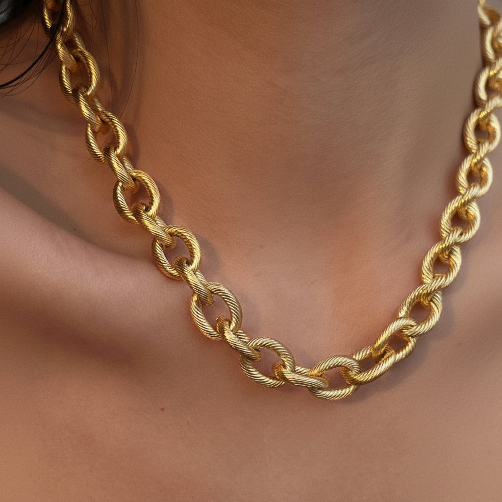 Elevate your everyday style with this chunky chain necklace, a timeless staple that works with any outfit. Crafted from waterproof, hypoallergenic stainless steel with 18K gold plating, this thick link design measures approximately 17" and resists tarnishing. The simple yet bold aesthetic makes it perfect for layering or wearing solo. To maintain its lustrous finish, avoid prolonged contact with lotions, perfumes, and cleaning products. A versatile piece that combines durability with understated elegance.