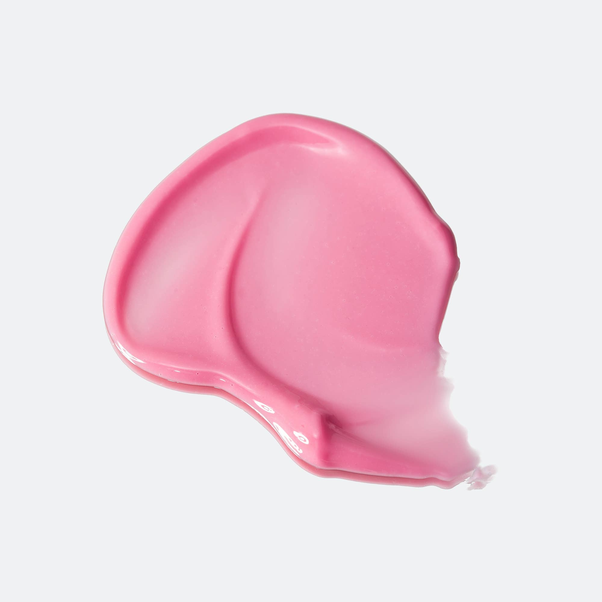 Pink cosmetic cream swatch on a light gray background