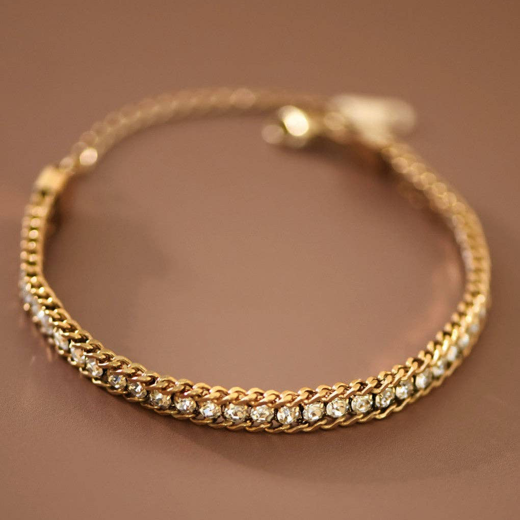 18K Gold Plated Stainless Steel Crystal Chain Bracelet with a sophisticated mixed-link design and sparkling clear crystal accents. This refined piece combines modern elegance with everyday wearability. Measuring 6.5" with a 2" extender, it adjusts to fit most wrists comfortably. Crafted from hypoallergenic stainless steel, it's waterproof and tarnish-resistant for lasting beauty. The double-strand tennis-style design features brilliant rhinestone detailing that catches the light beautifully.