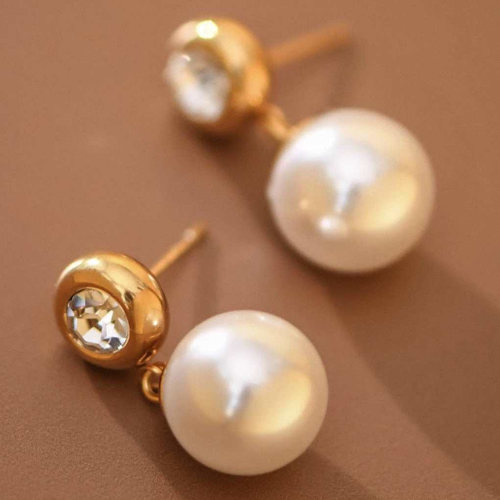 Elevate your everyday look with these elegant 18K gold-dipped stainless steel earrings featuring lustrous pearl drops. Measuring approximately 1" in length, they offer a timeless aesthetic that complements any style. Crafted for durability, these earrings are hypoallergenic, waterproof, and tarnish-resistant—perfect for sensitive skin and active lifestyles. To maintain their radiant finish, avoid prolonged contact with lotions, perfumes, and cleaning products. A versatile essential.