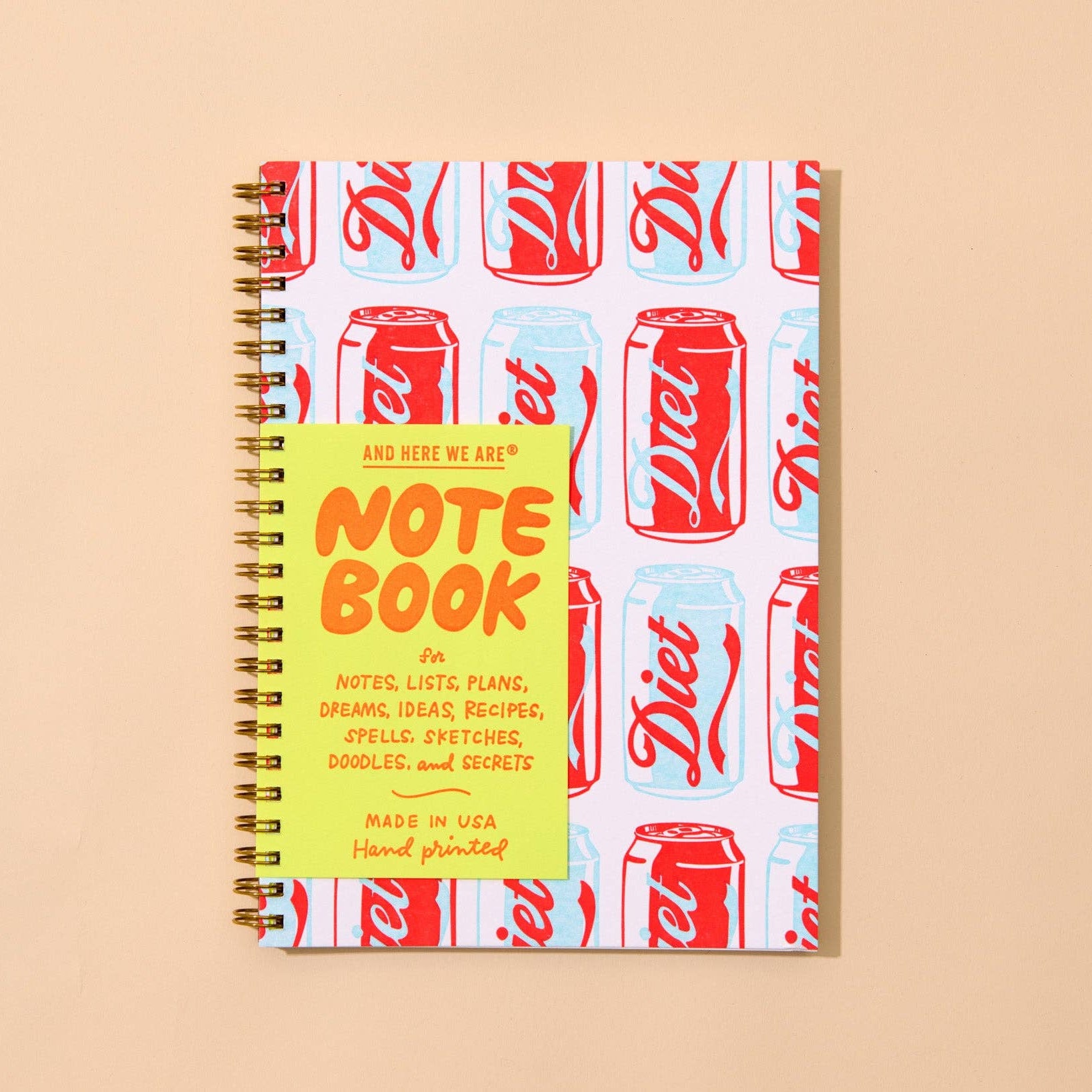 Notebook with Coca-Cola can design on a beige background