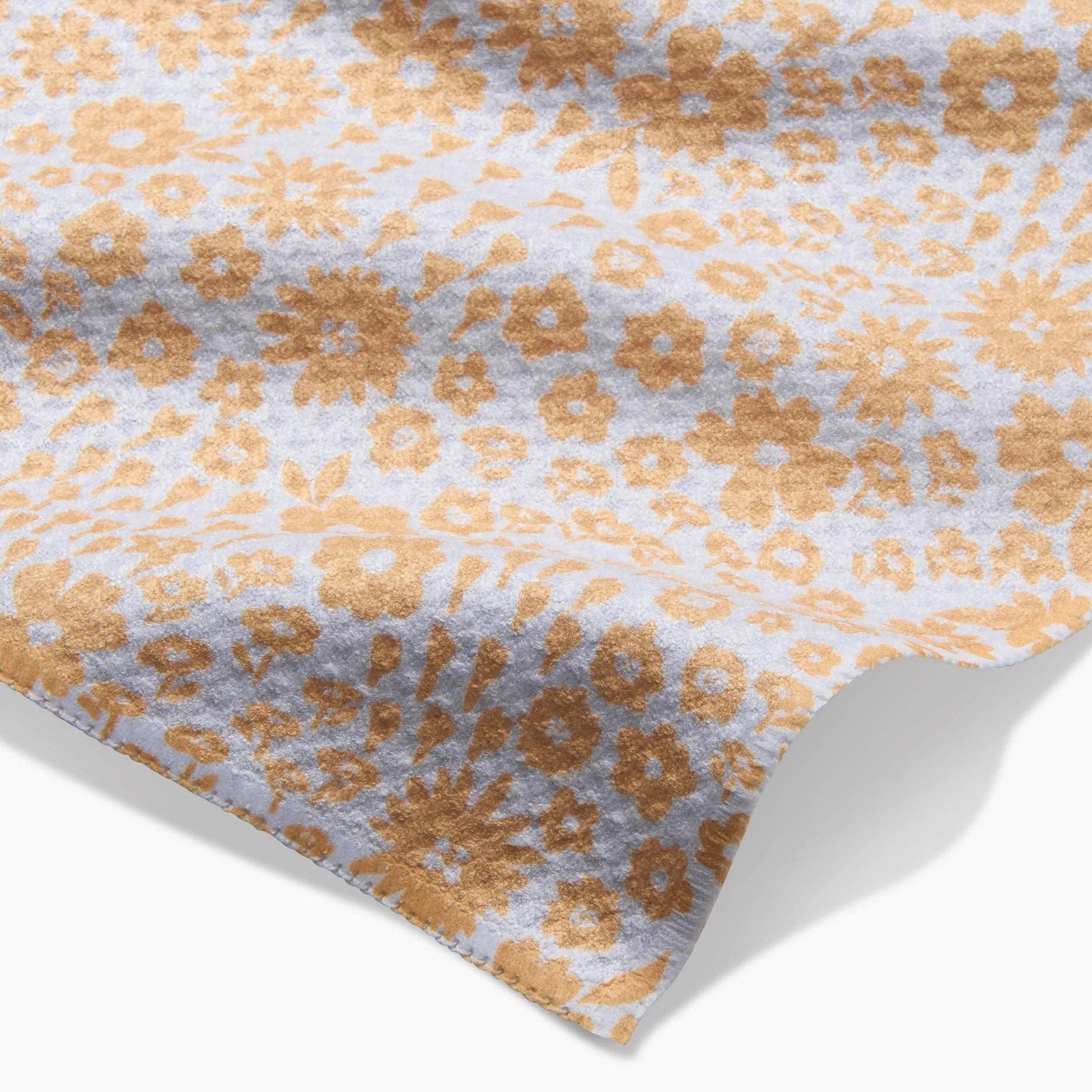 Close-up of a fabric with a floral pattern on a white background Tea Towel